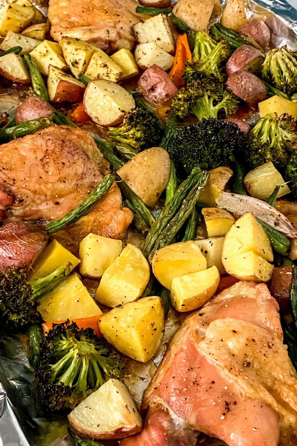 Sheet pan covered in chicken and vegetables