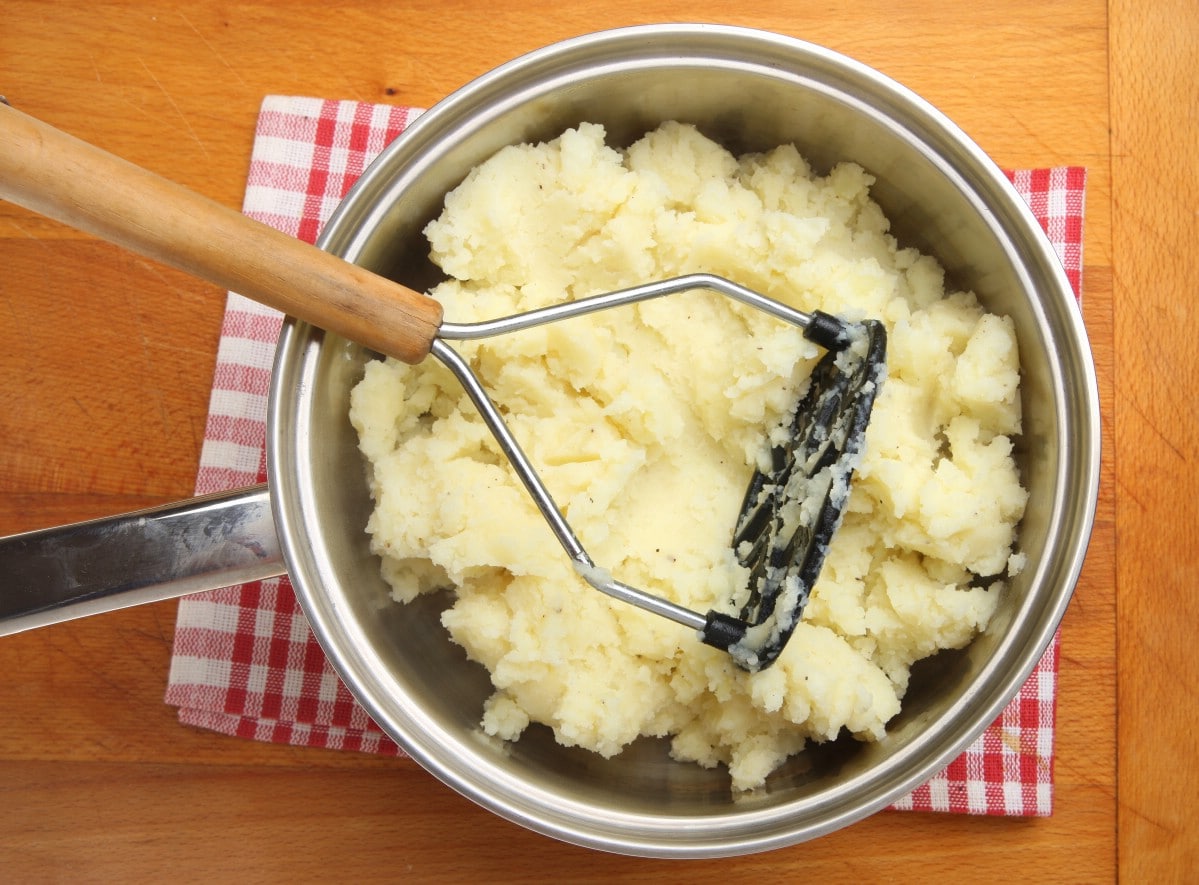 Fresh mashed potatoes in a steel pot.