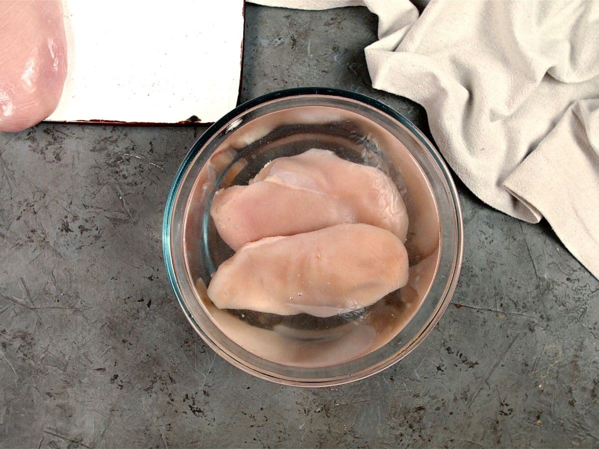 Glass bowl of chicken in brine