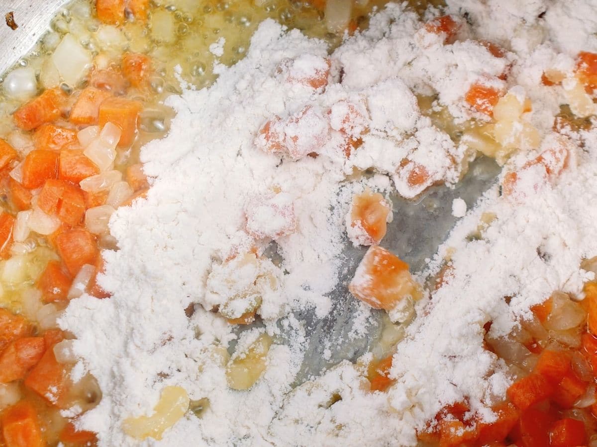 Flour in pan with onion and carrot