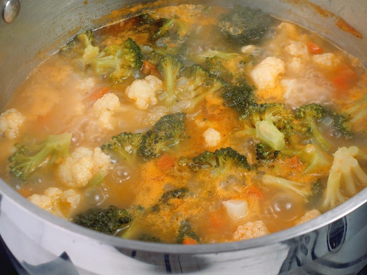 Broccoli and cauliflower in stockpot with cheese