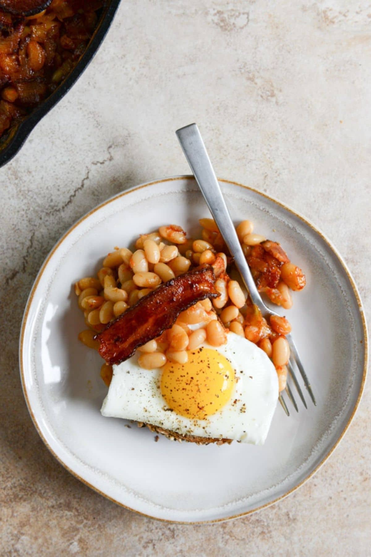 whiet plate with toast egg and beans