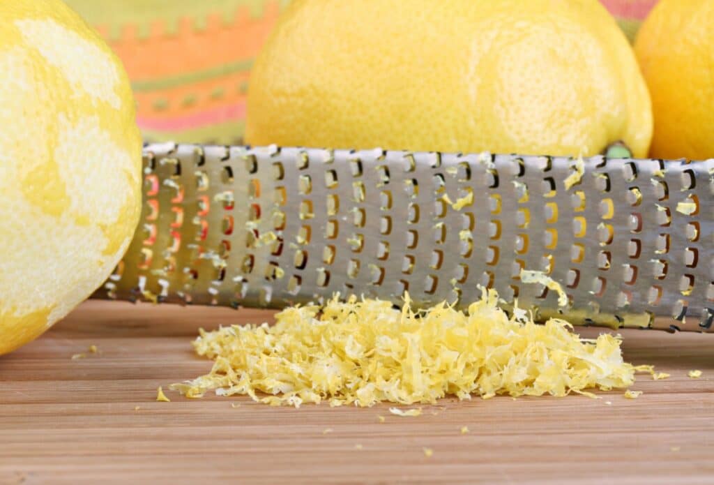 Lemon zest on a rustic cutting board.