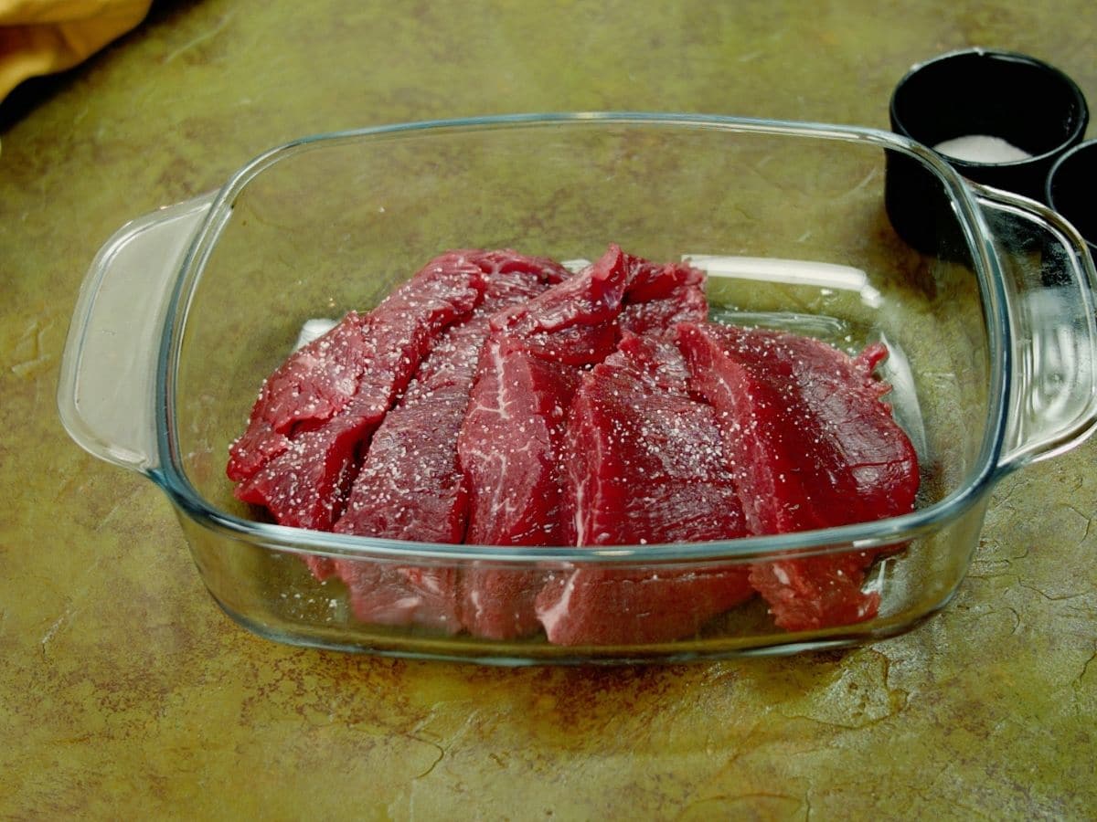 Sliced steak in rectangular glass bowl