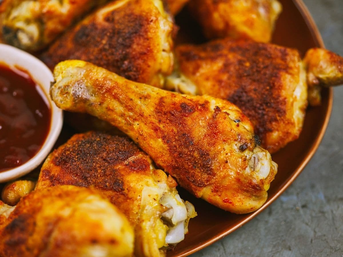 Crispy baked chicken legs on brown platter