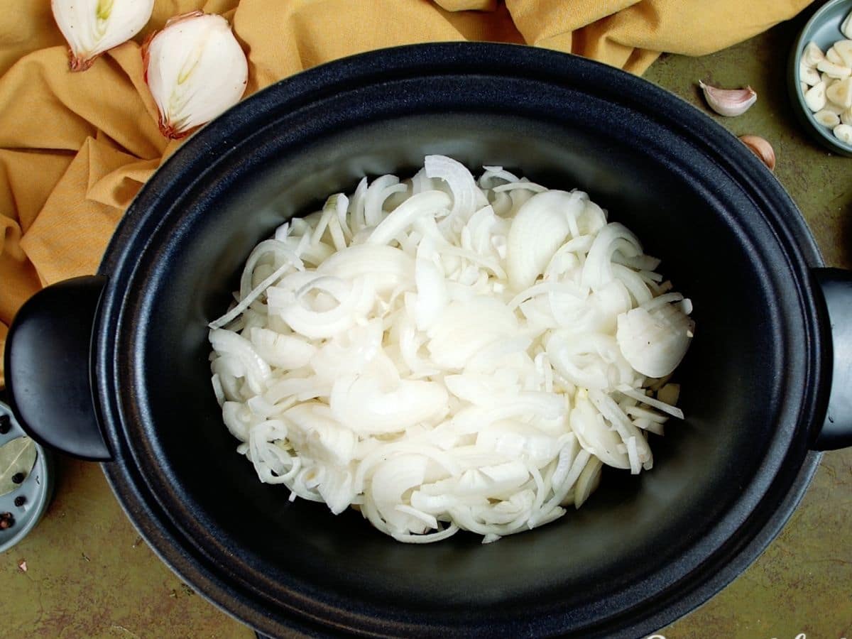 White onions in black slow cooker