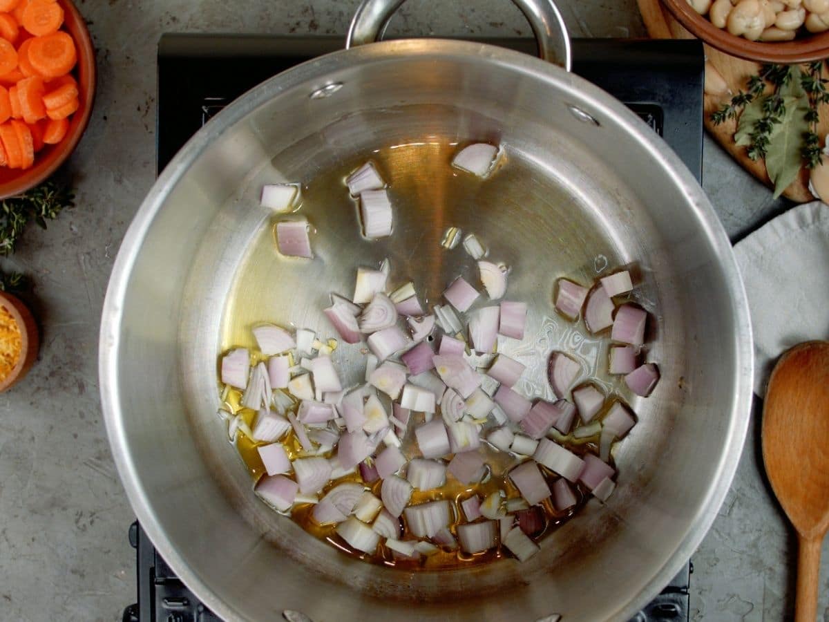 Red onion being cooked in large stockpot