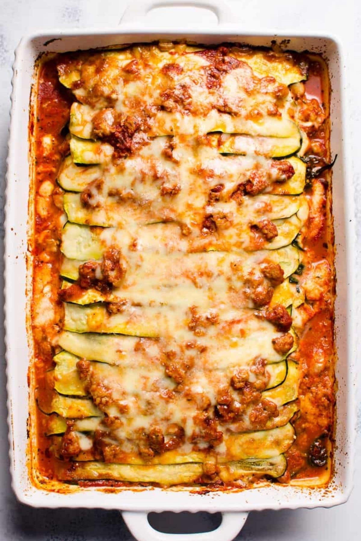White baking dish filled with lasagna with zucchini pasta