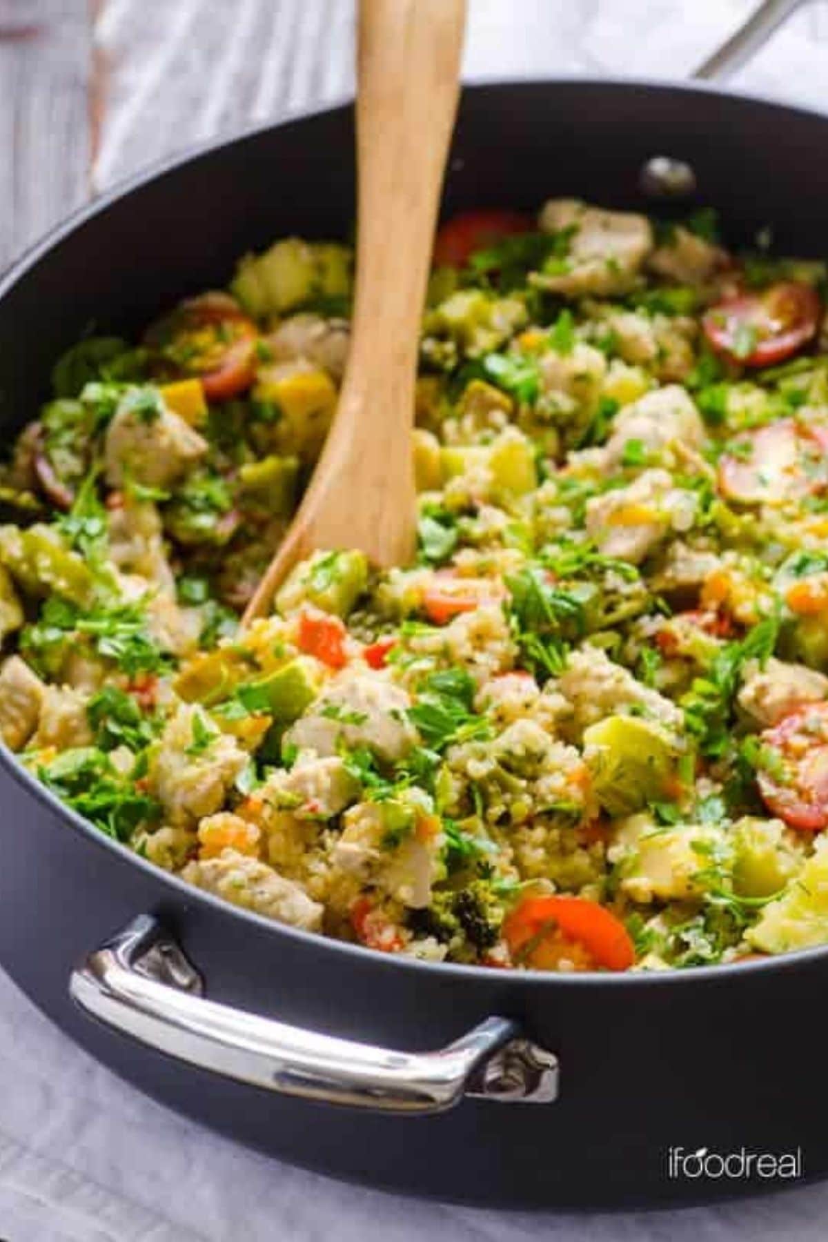 Black skillet filled with quinoa and vegetables