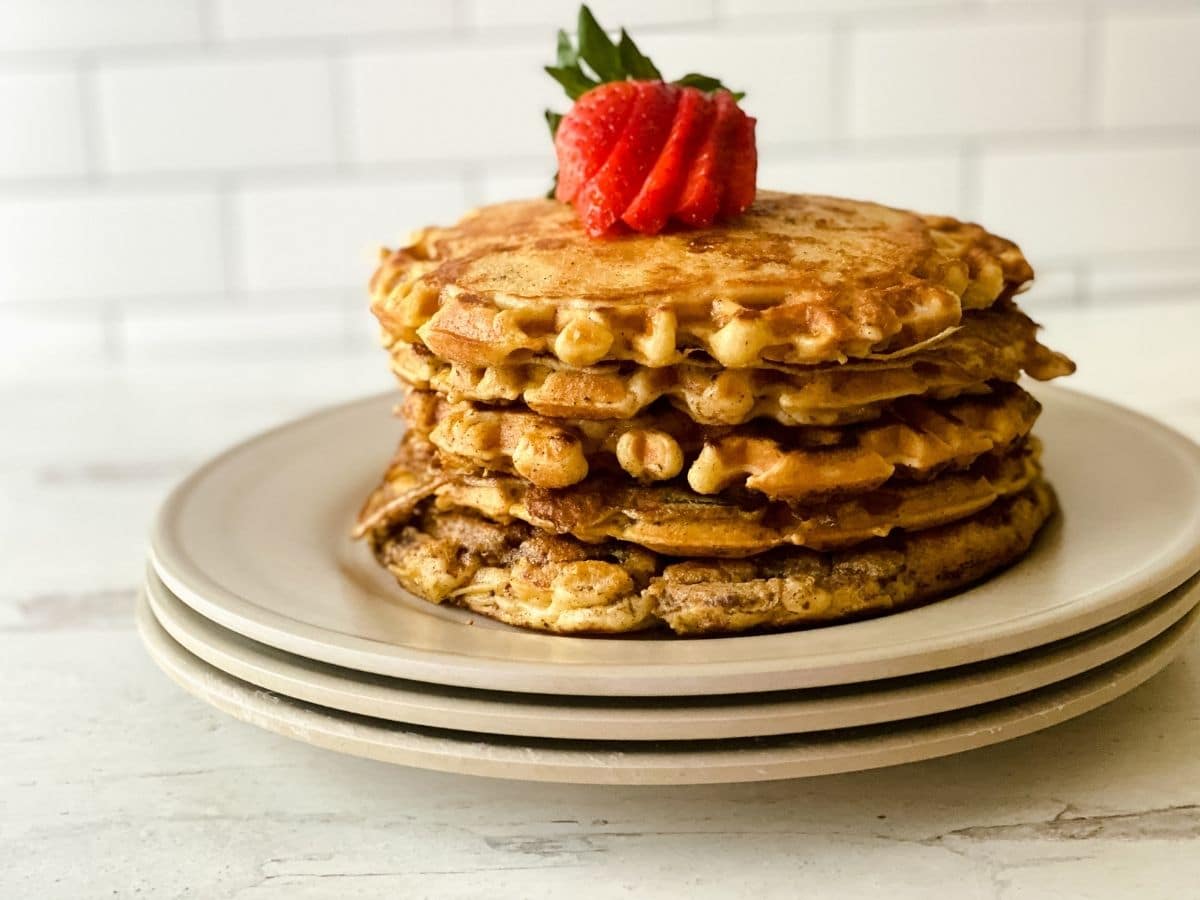 stack of plates with a stack of waffles on top