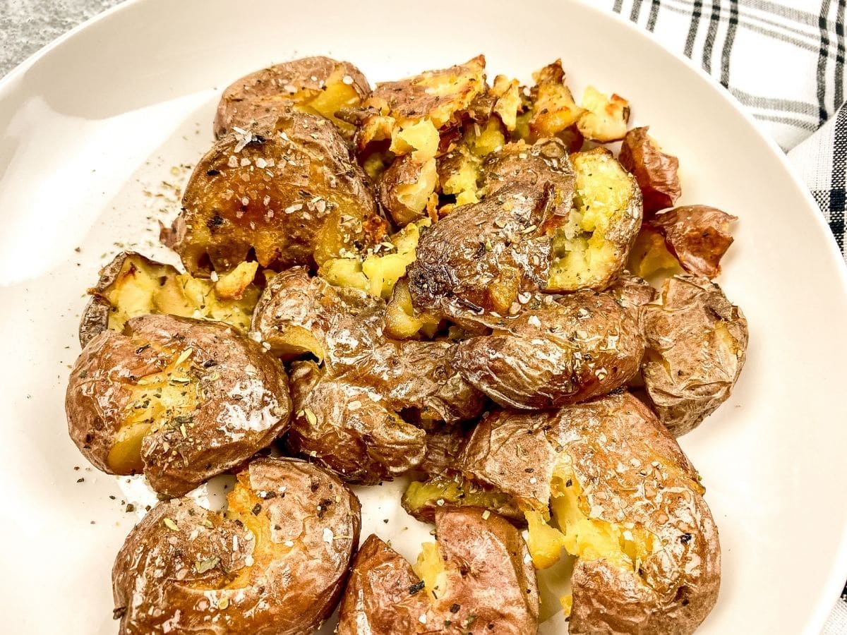 smashed potatoes on plate with napkin underneath