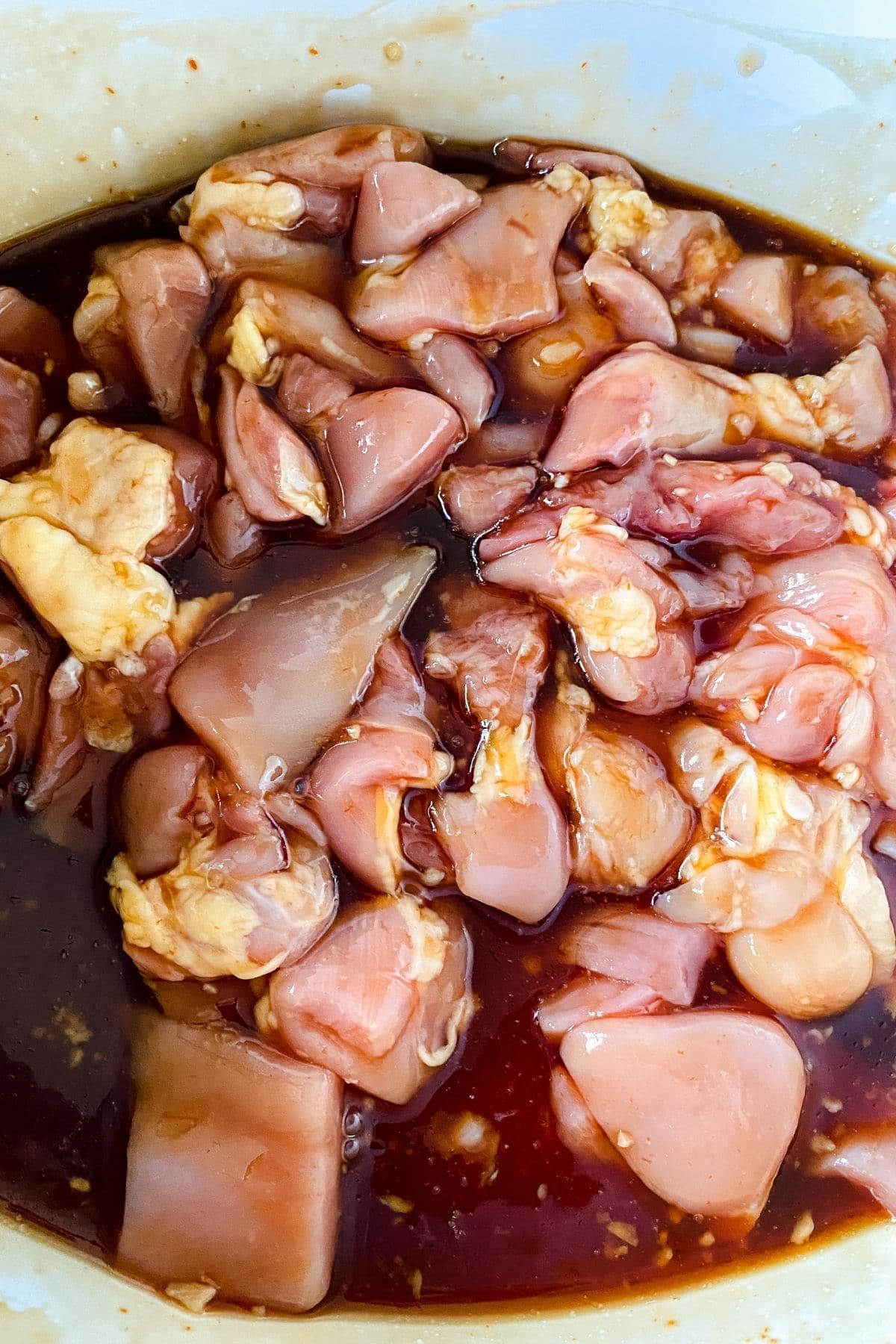 raw chicken in sauce in crockpot