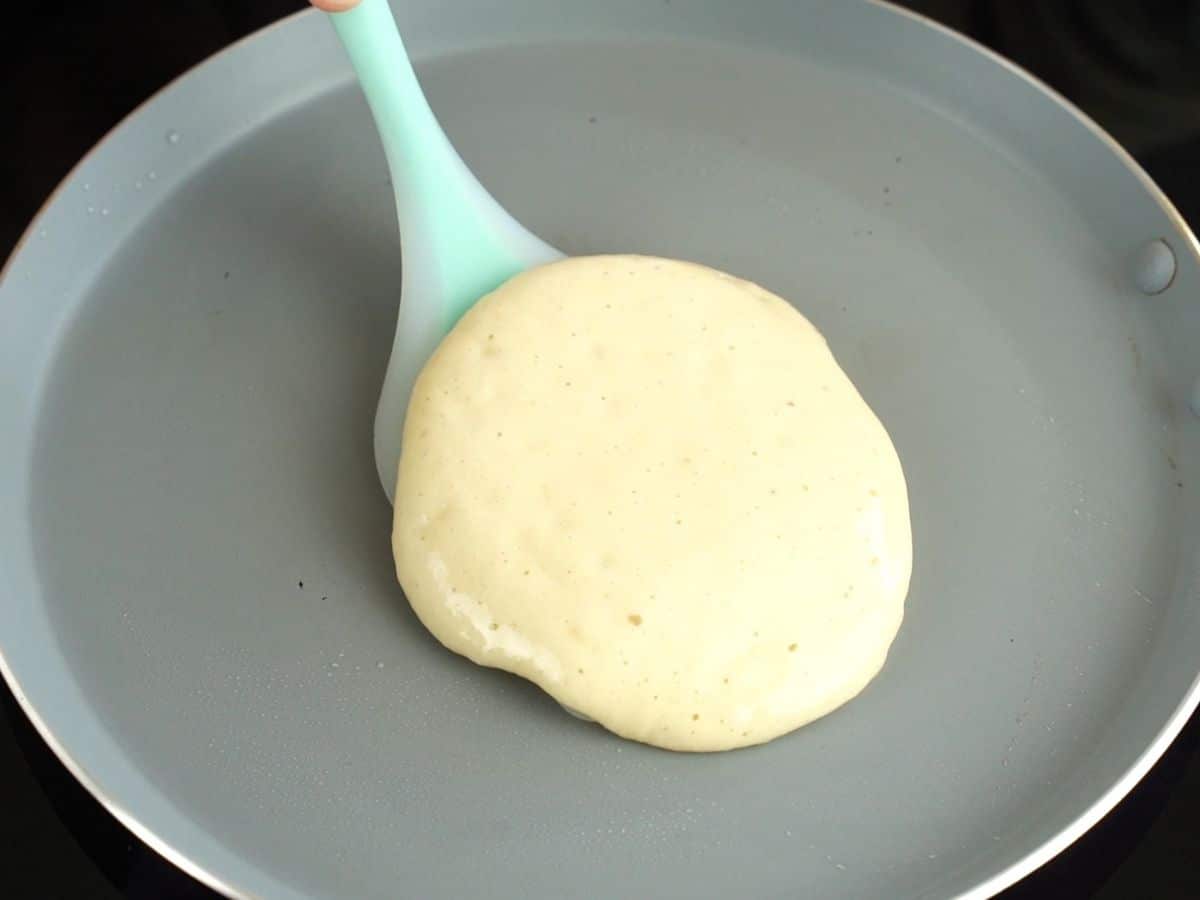 pancake being flipped with blue spatula