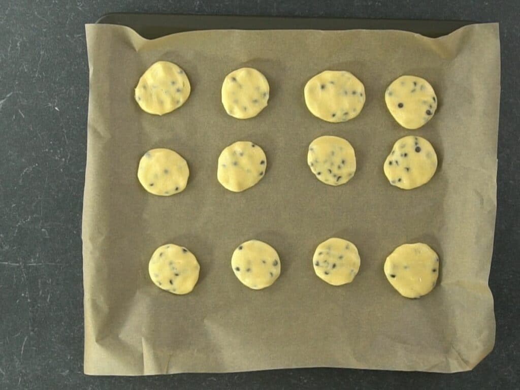 raw cookies on parchment paper lined baking sheet
