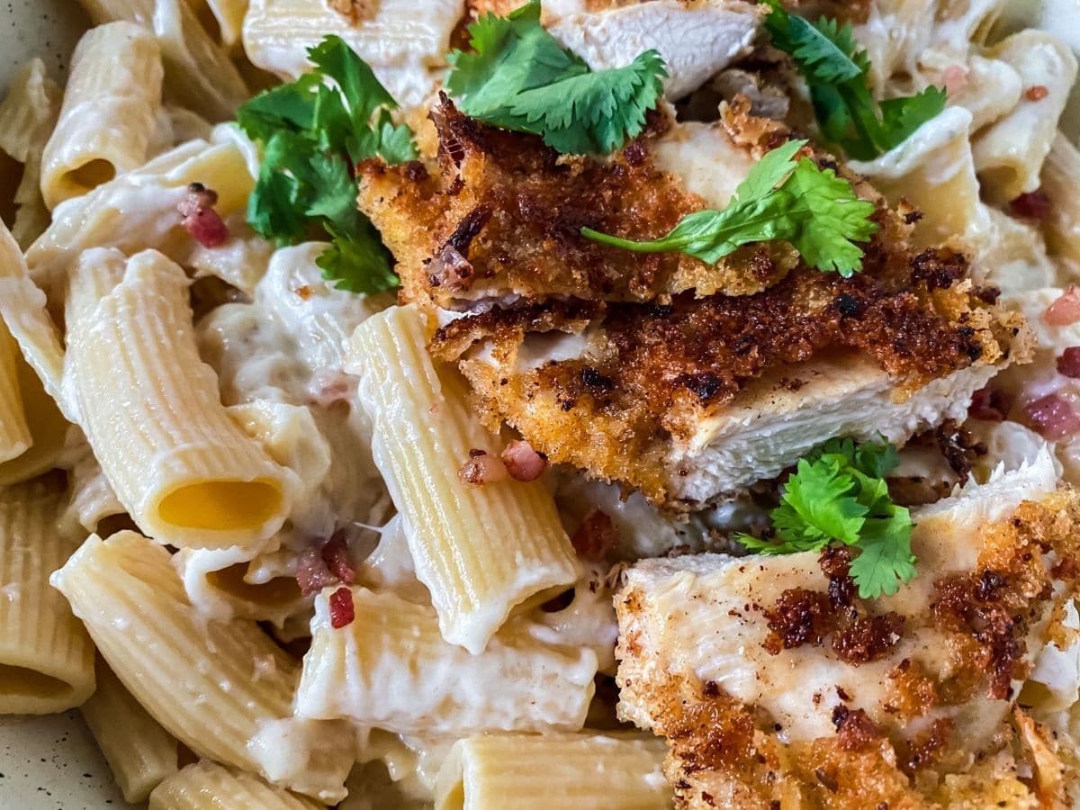 pasta with chicken and parsley on top