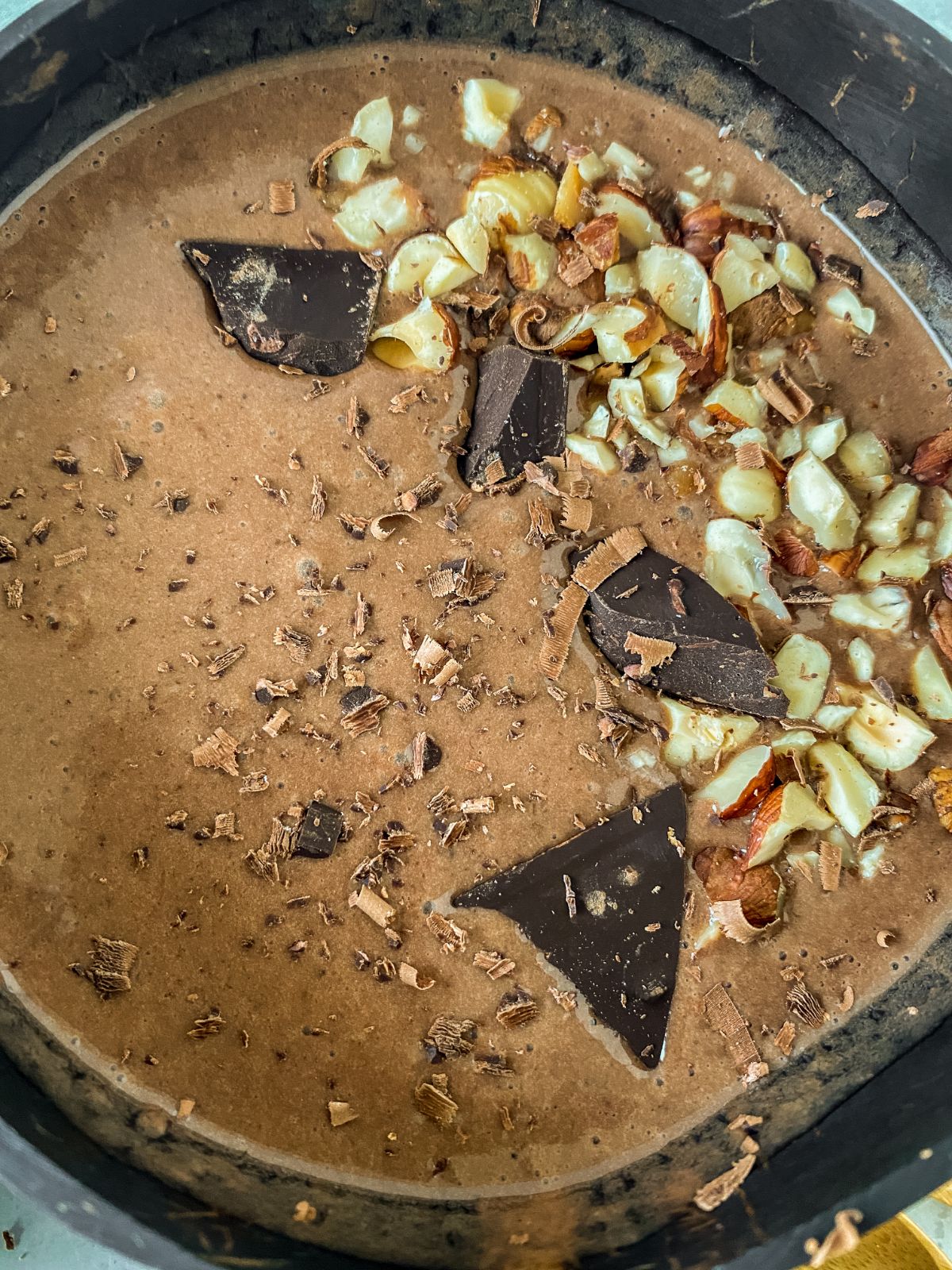 chocolate chunks on top of smoothie bowl with nuts