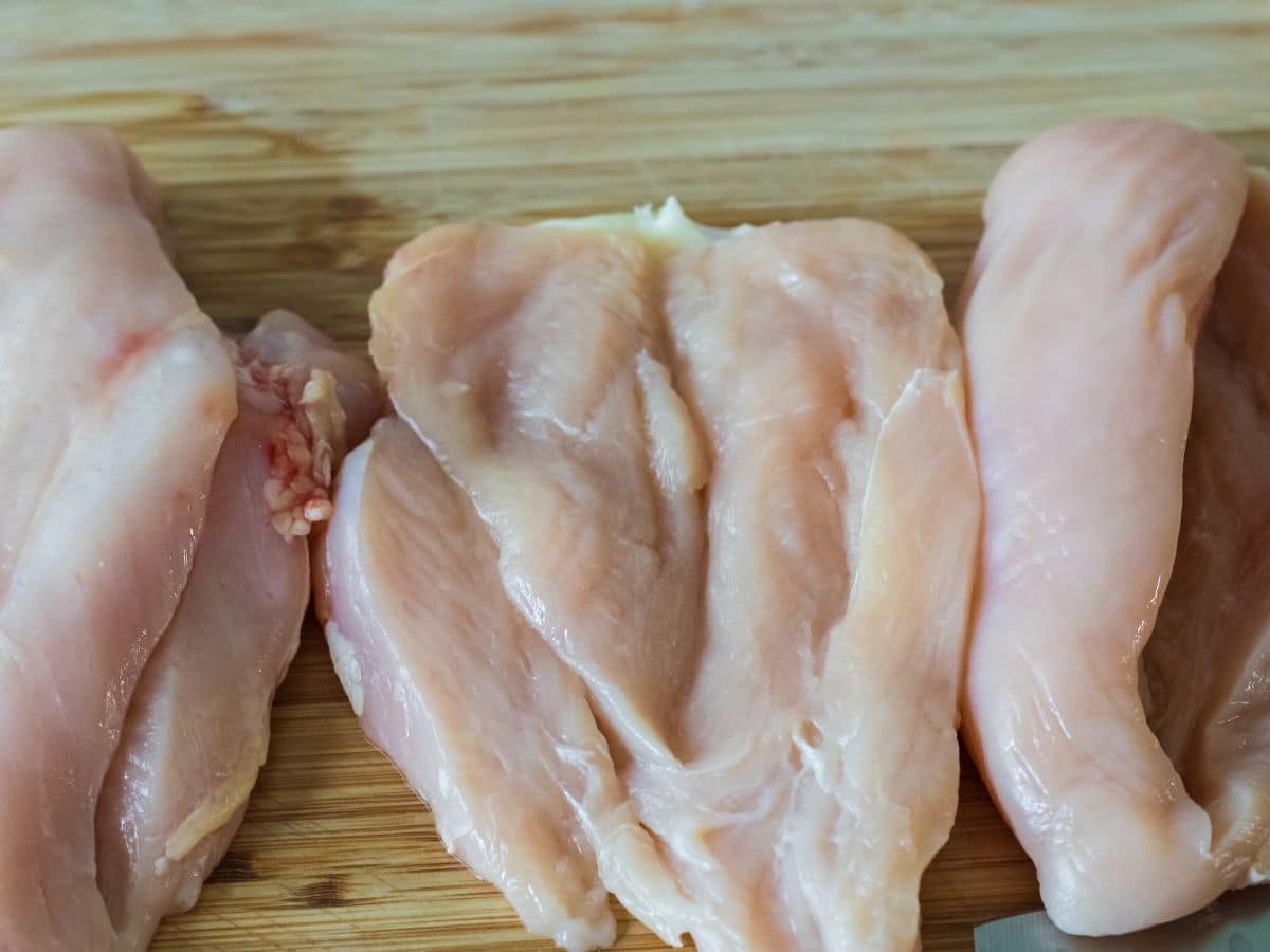 butterfly chicken breasts on cutting board