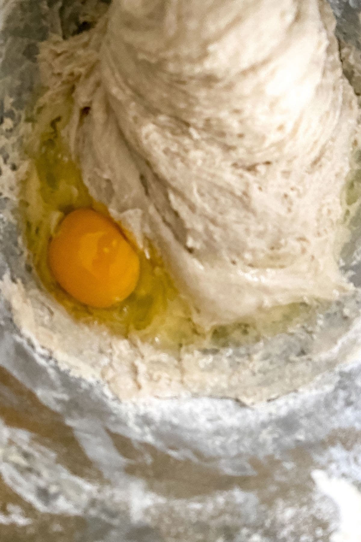 egg on top of dough in bowl