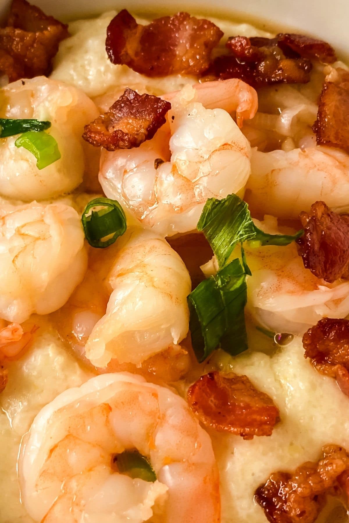 close up image of shrimp on top of bowl of grits