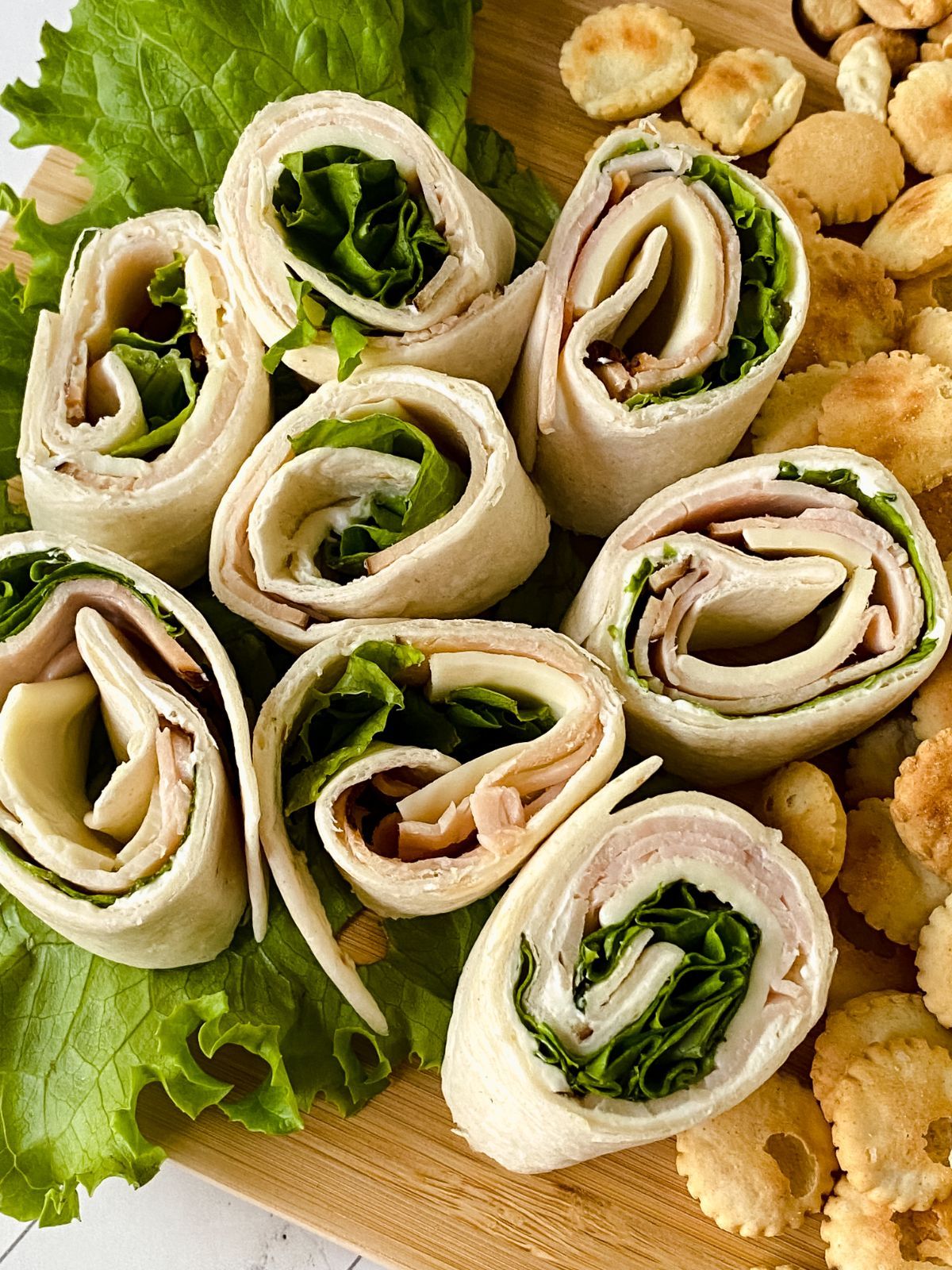 close up image of sliced tortilla wraps on romaine lettuce leaves