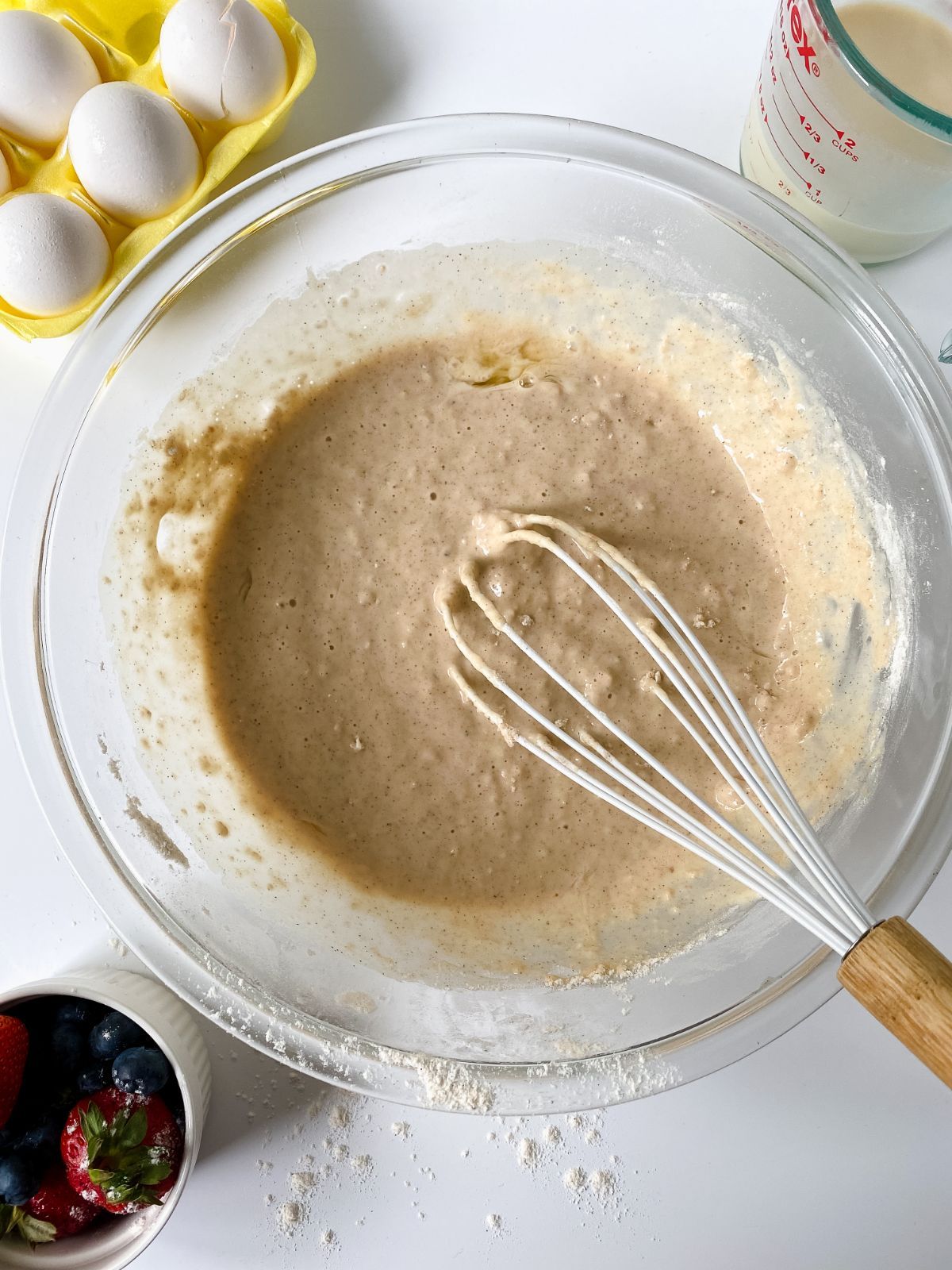 whisk in glass bowl of waffle batter