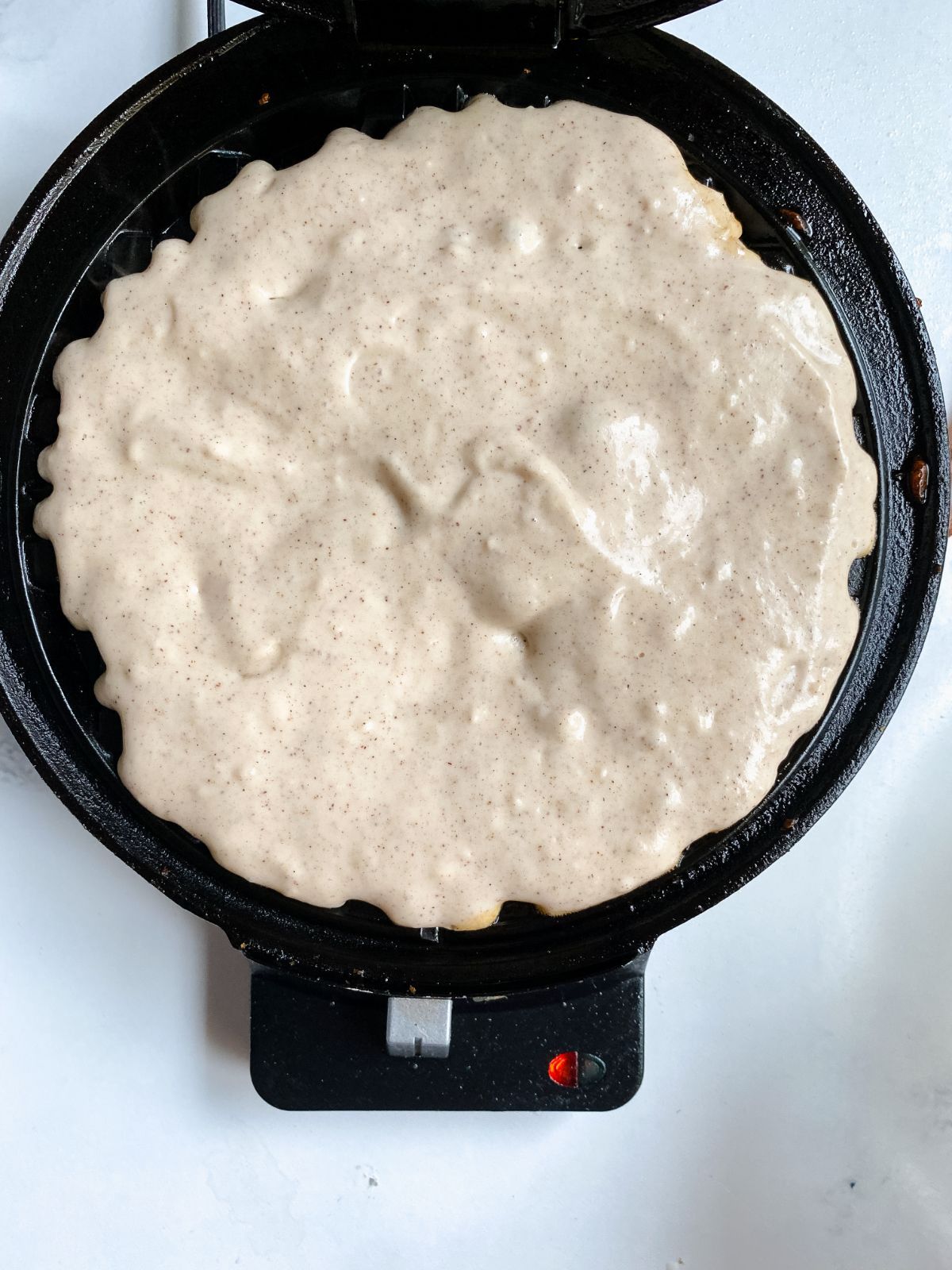 waffle batter in hot waffle maker