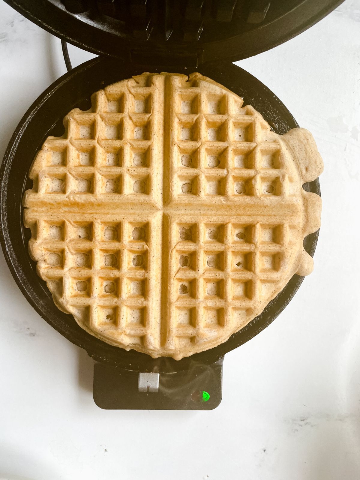 cooked waffle in black waffle maker