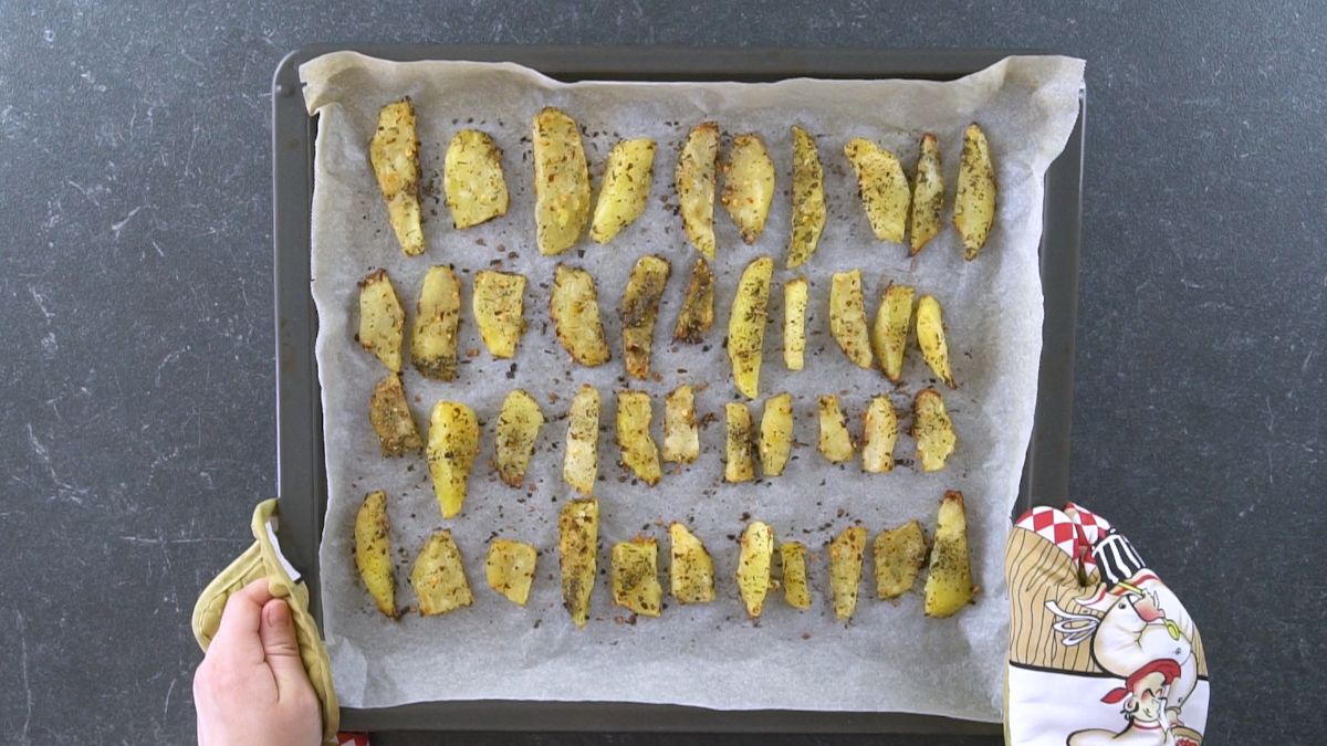 seasoned potatoes on baking sheet before going into oven