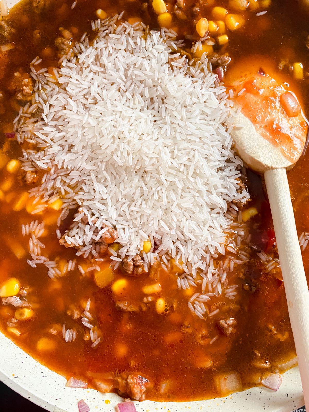 rice in skillet with tomato sauce