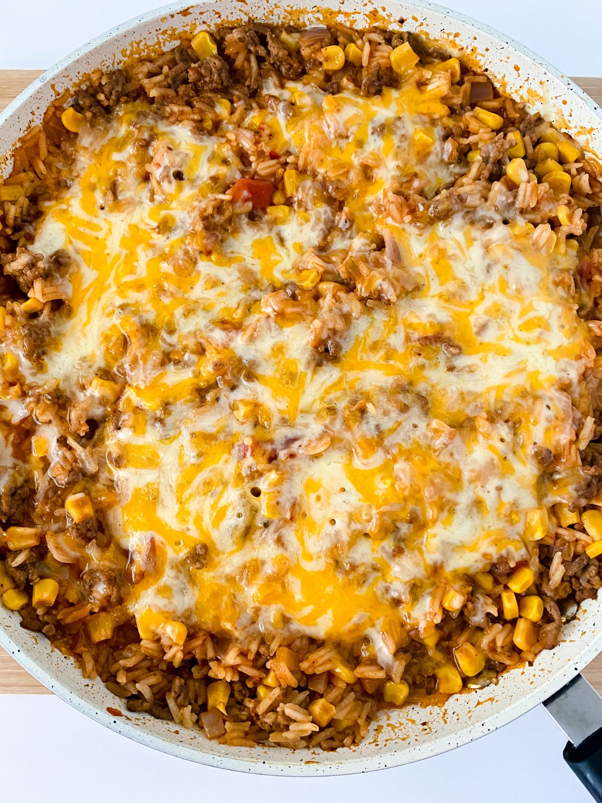 cheesy Mexican rice with beef in round casserole dish