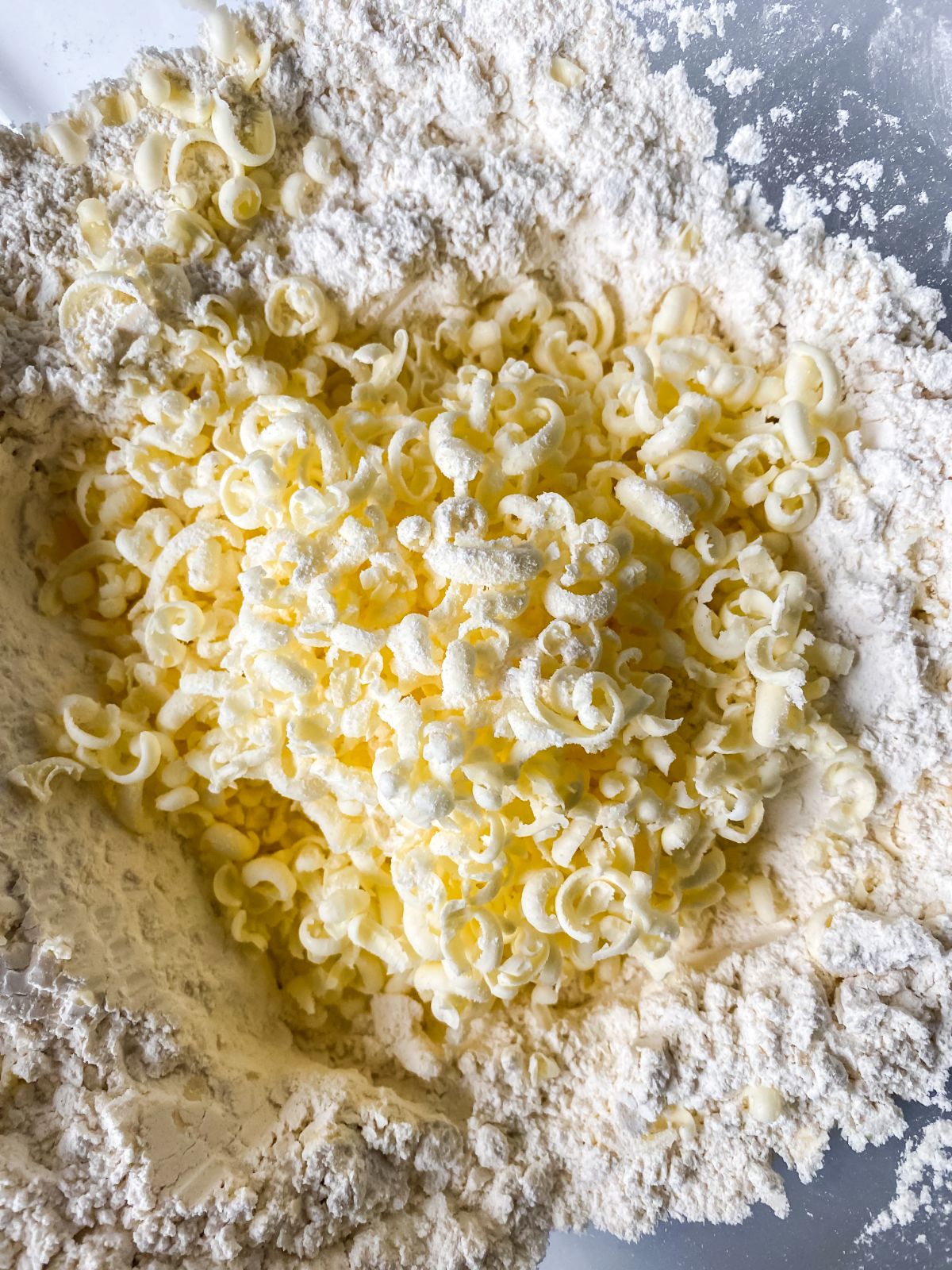 butter grated into bowl of flour
