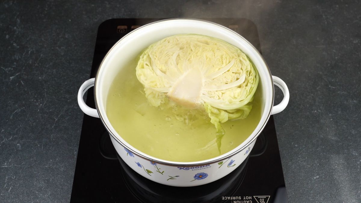 cabbage head in stockpot on hot plate