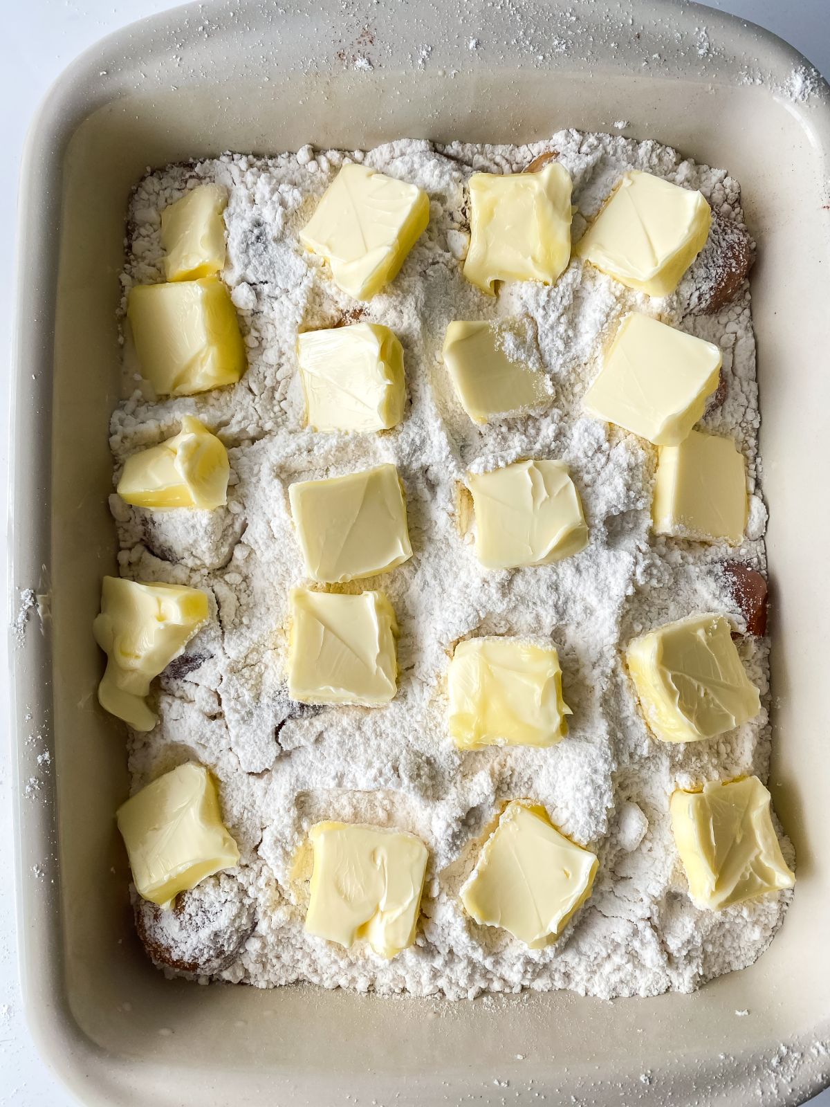 baking dish with slices of butter over the top