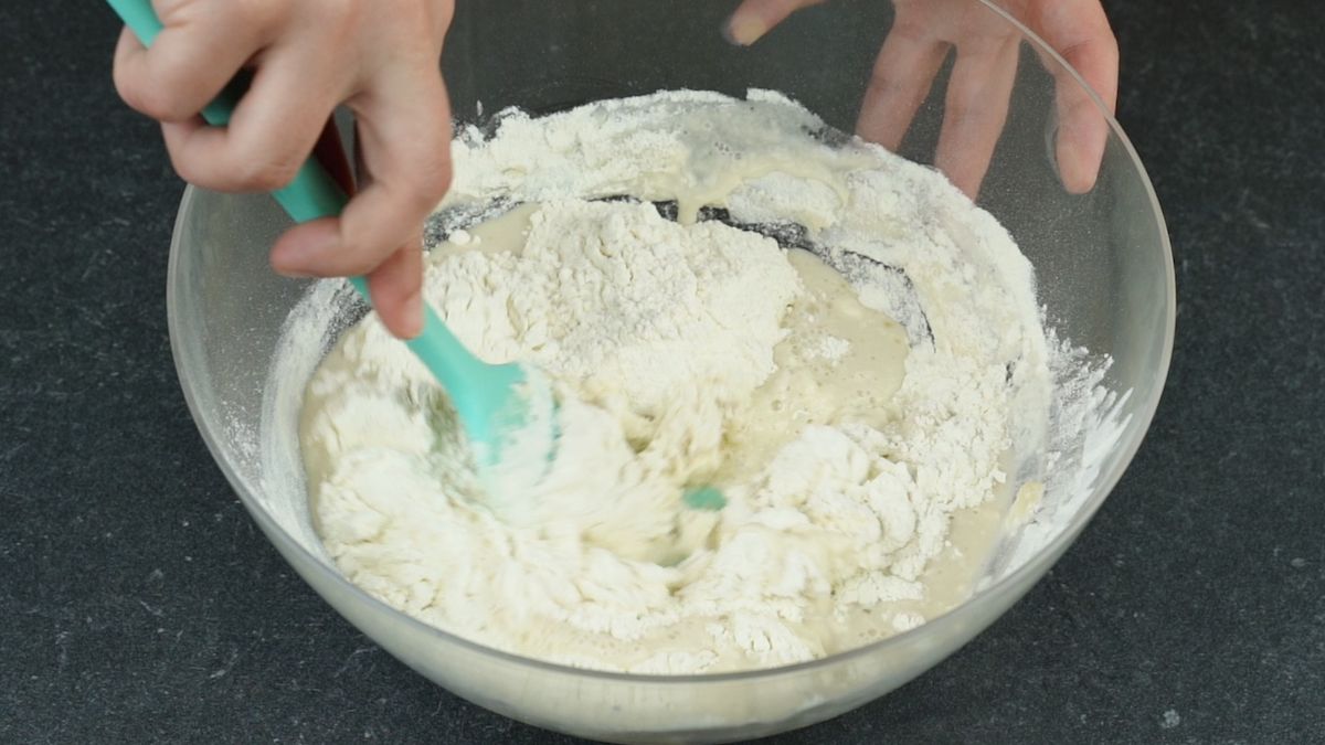 teal spatula in bowl with flour
