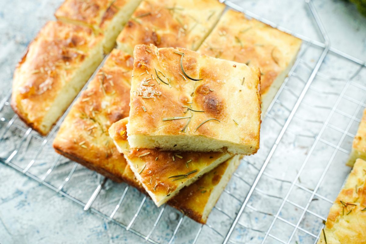 stacked focaccia bread with rosemary on wire rack