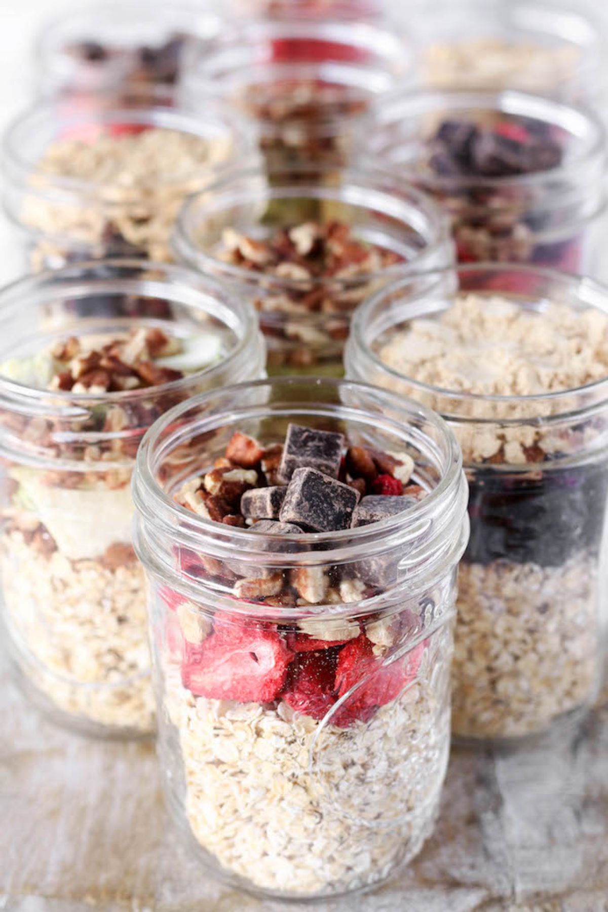 mason jars of oats with fruit on counter