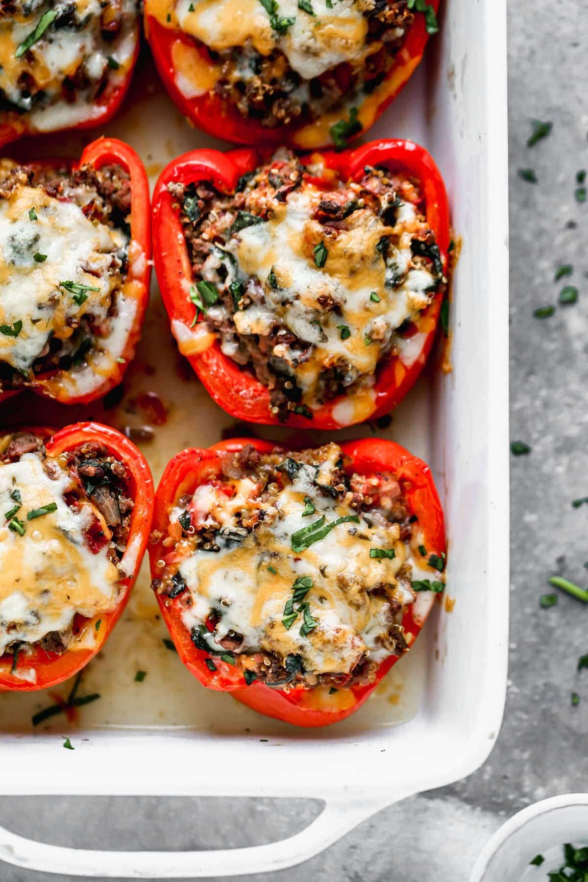 red stuffed peppers in white baking dish