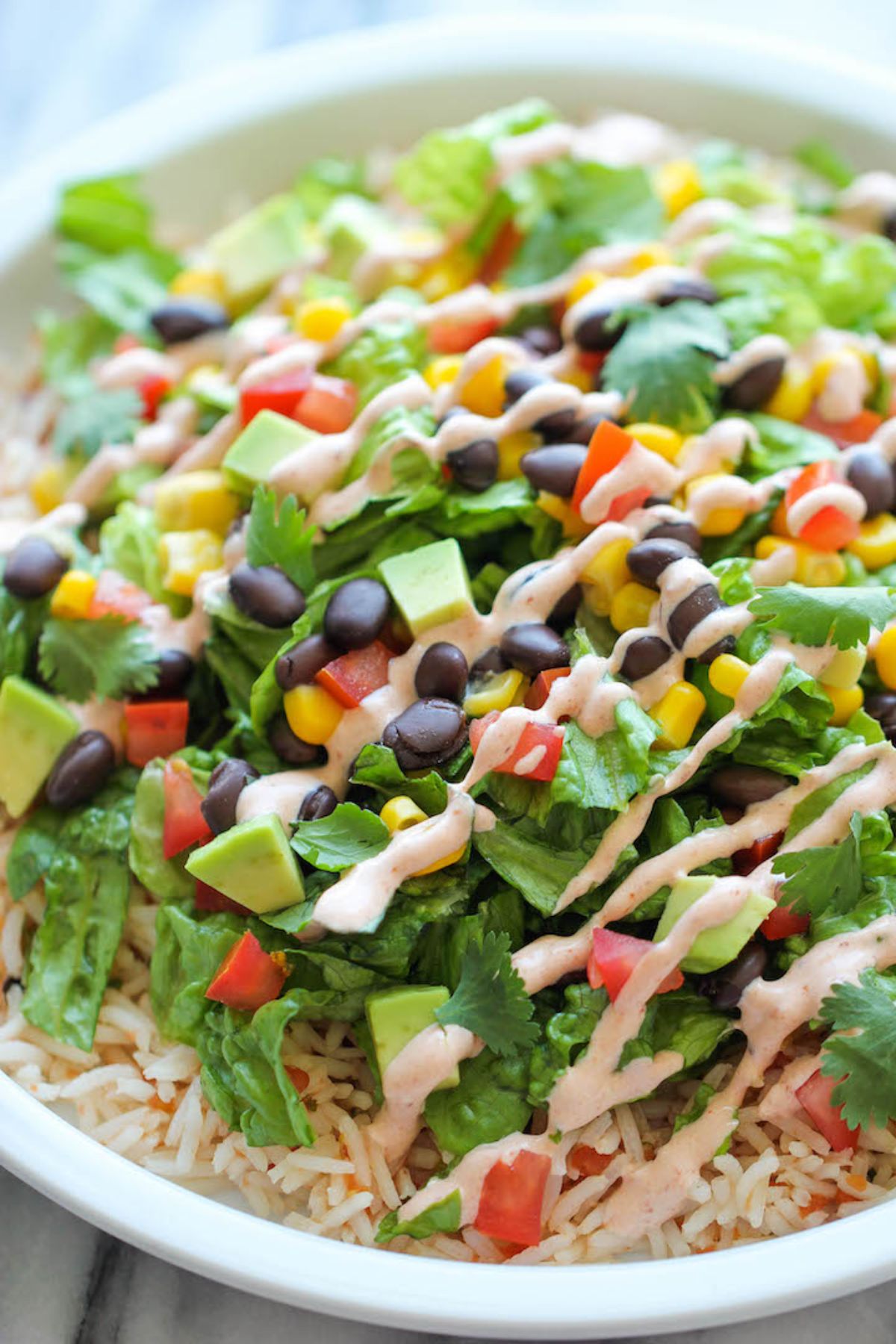 salad with beans and corn with drizzle of dressing on top