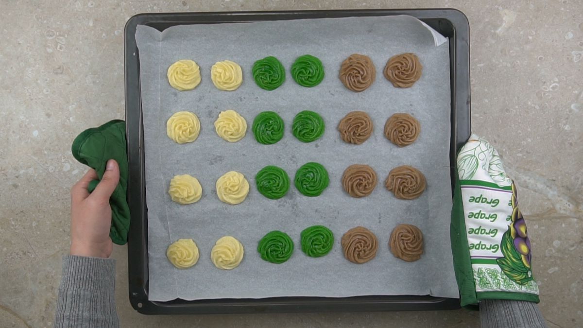 baking sheet covered in green white and brown cookies