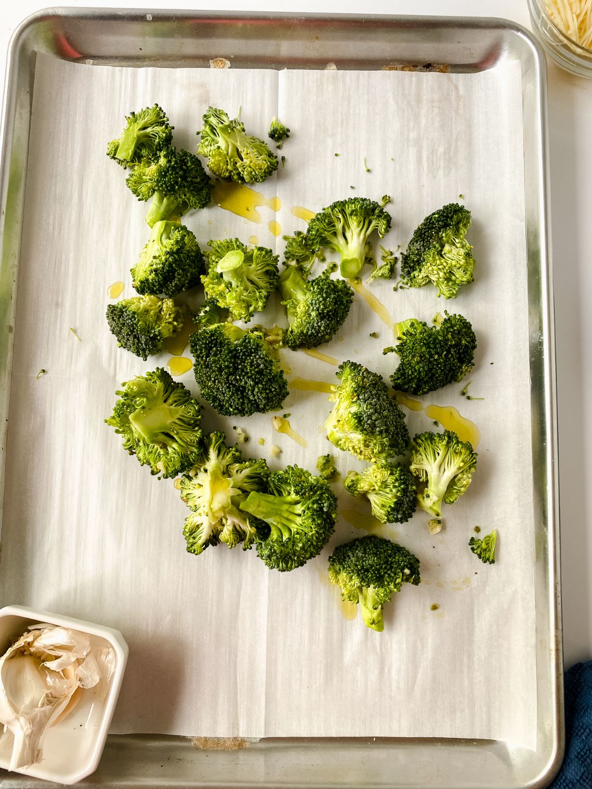 broccoli on parchment paper on baking sheet before baking