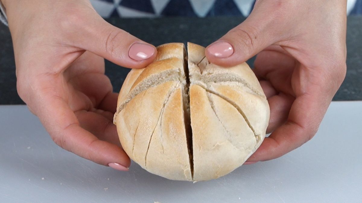 hands holding bun with slits in top