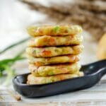 stack of potato cakes on black large spoon plate sitting on wood table
