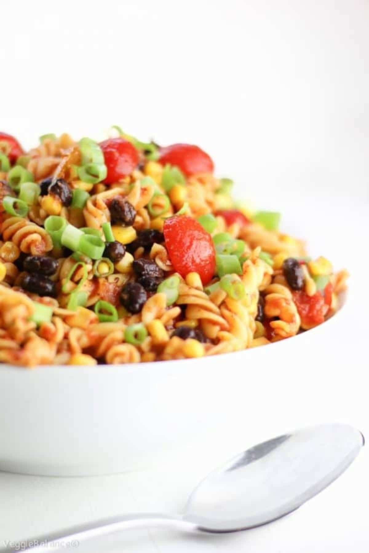 white bowl of taco pasta with tomatoes