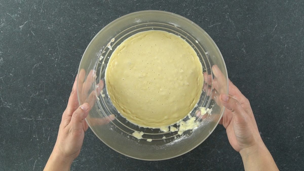 flour dough starter in glass bowl