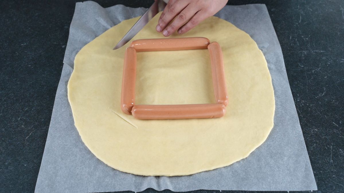 sausages in square in middle of dough