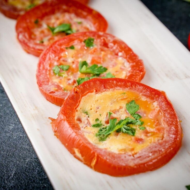 white platter holding tomato egg rings