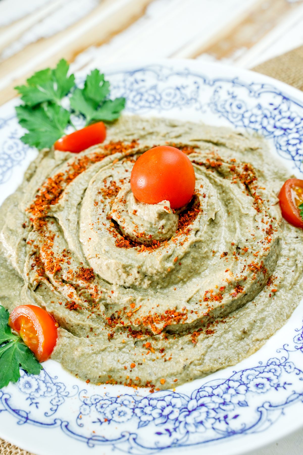 baba ganoush in blue and white bowl with paprika on top