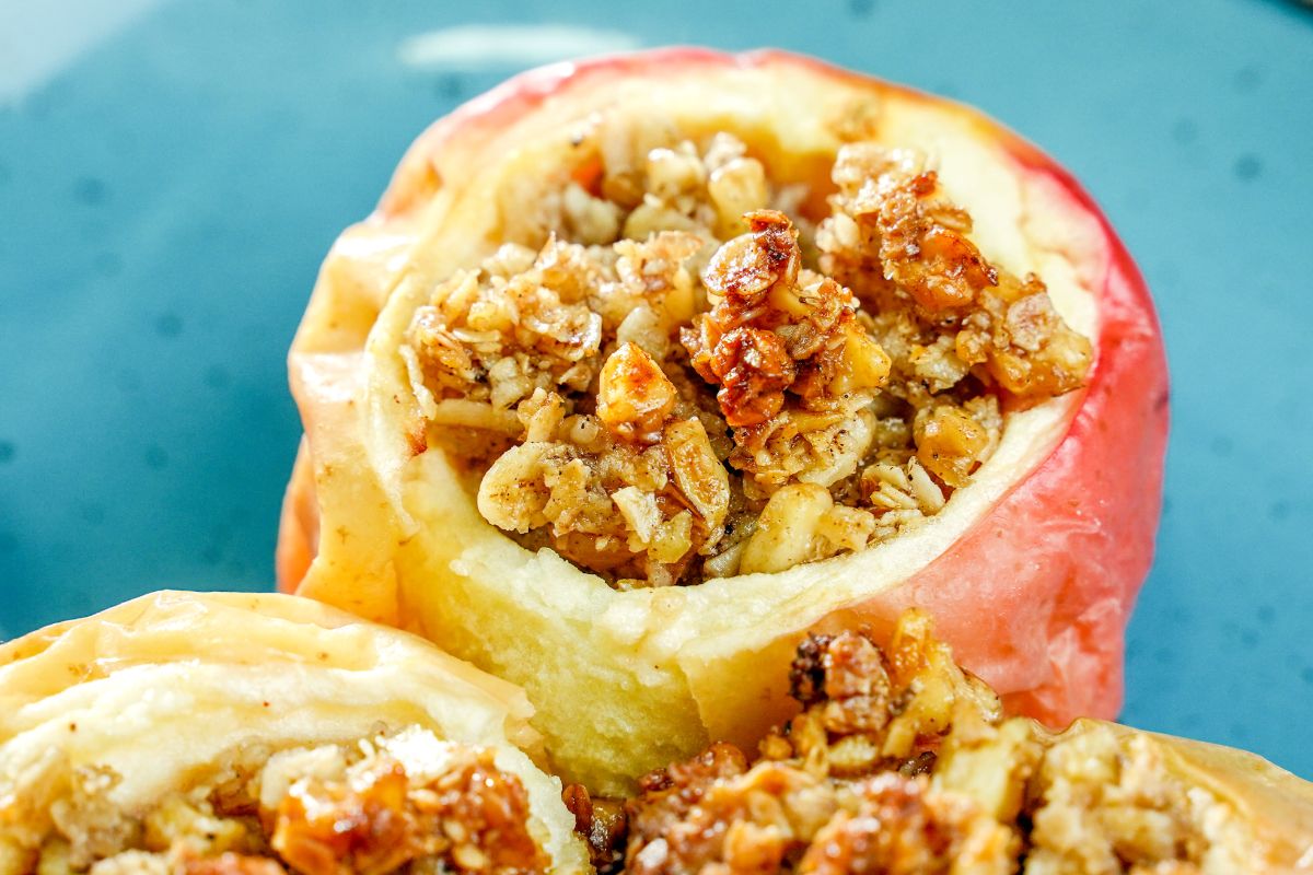 close up image of baked apple with oatmeal top
