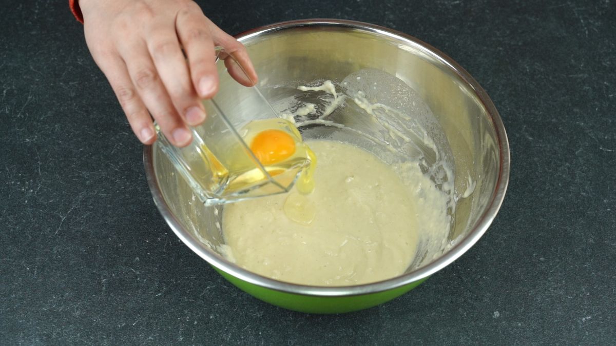 egg being added to yeast in bowl