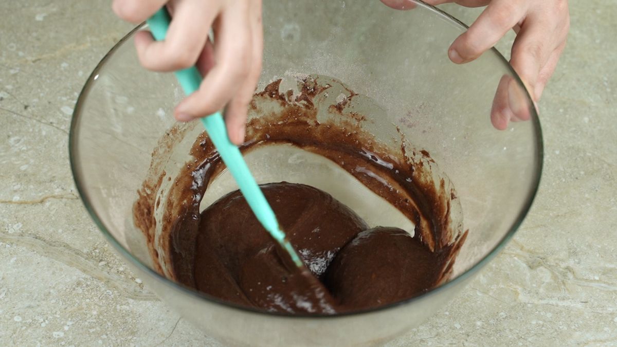 spatula in glass bowl of chocolate cake batter